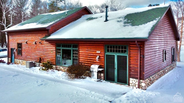 view of snow covered back of property