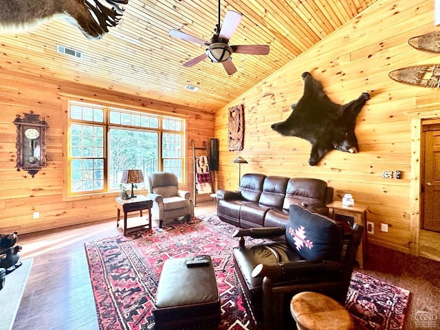 living room with vaulted ceiling, hardwood / wood-style flooring, wooden walls, and wooden ceiling