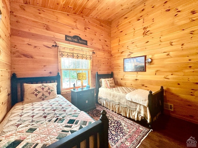 bedroom featuring wooden ceiling, lofted ceiling, and wooden walls