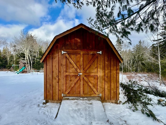 snow covered structure featuring a playground