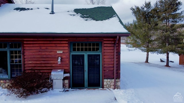 view of snow covered property entrance