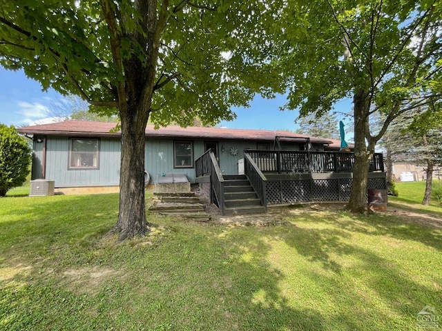 view of front facade with a deck and a front lawn