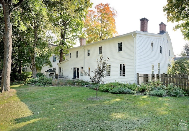 rear view of property with a yard