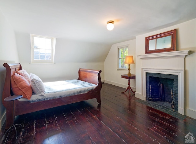 bedroom featuring dark wood-type flooring and vaulted ceiling