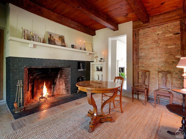 sitting room featuring hardwood / wood-style floors, beamed ceiling, and wooden ceiling