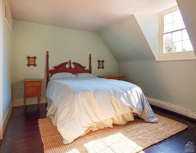 bedroom with dark hardwood / wood-style floors, vaulted ceiling, and a baseboard heating unit