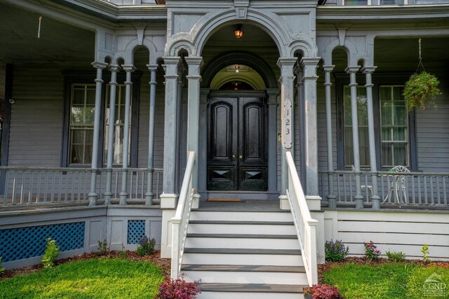 doorway to property featuring covered porch