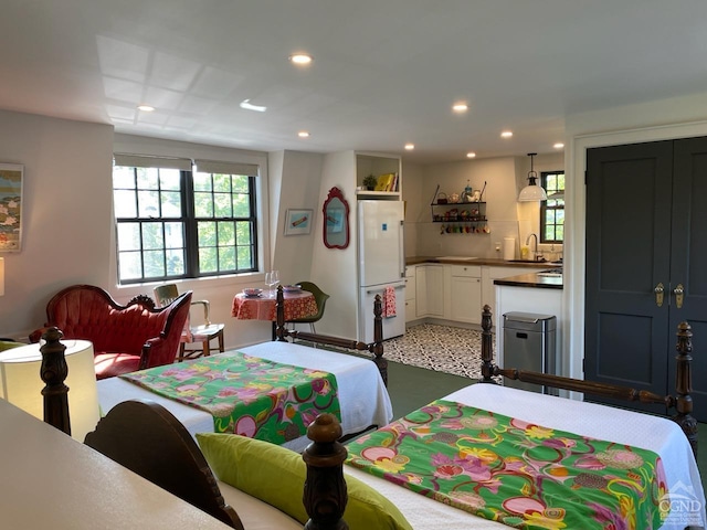 bedroom featuring white refrigerator and sink