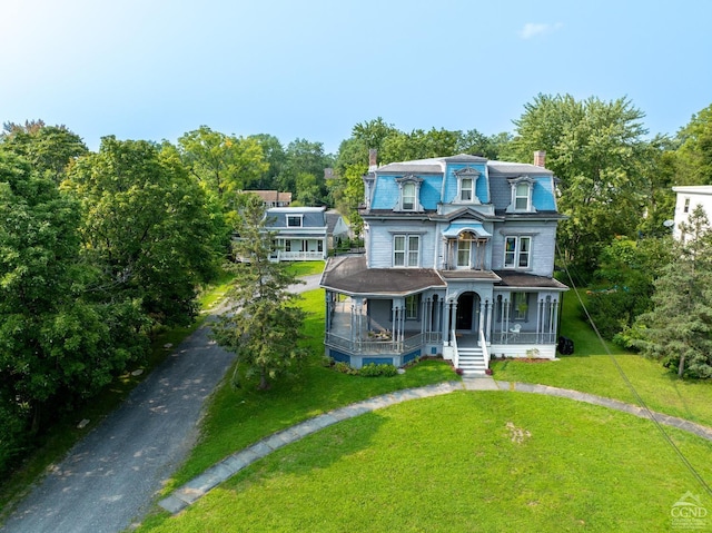 view of front of home featuring covered porch and a front yard