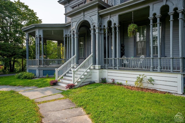 view of exterior entry featuring covered porch