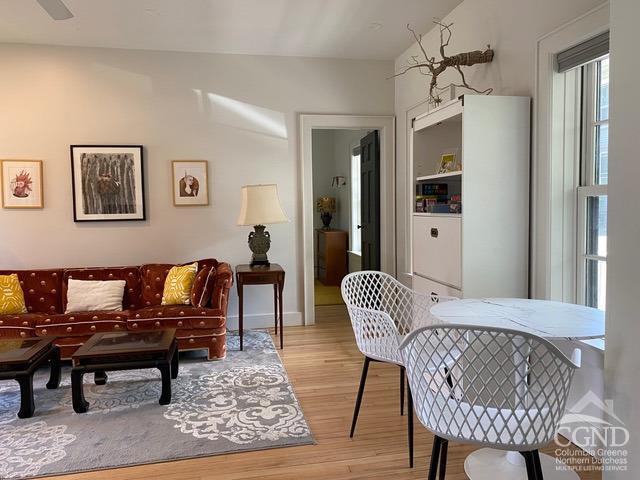 interior space featuring light hardwood / wood-style floors and vaulted ceiling