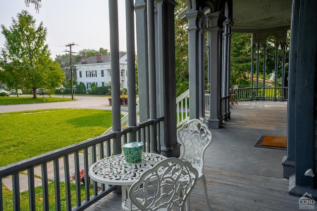 deck with covered porch and a yard