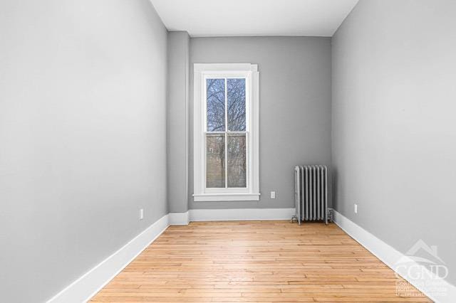 empty room featuring light hardwood / wood-style floors and radiator