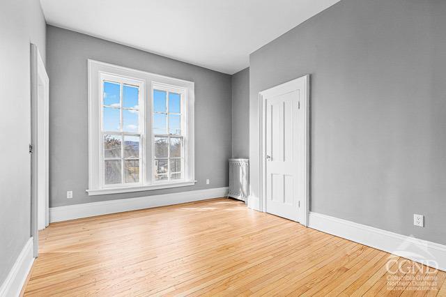 empty room with light hardwood / wood-style flooring