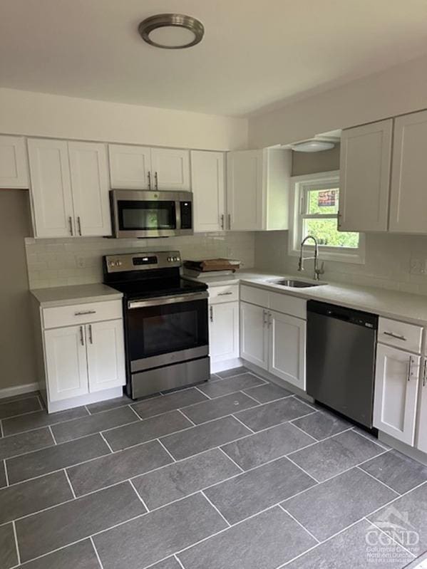 kitchen with white cabinetry, sink, and appliances with stainless steel finishes