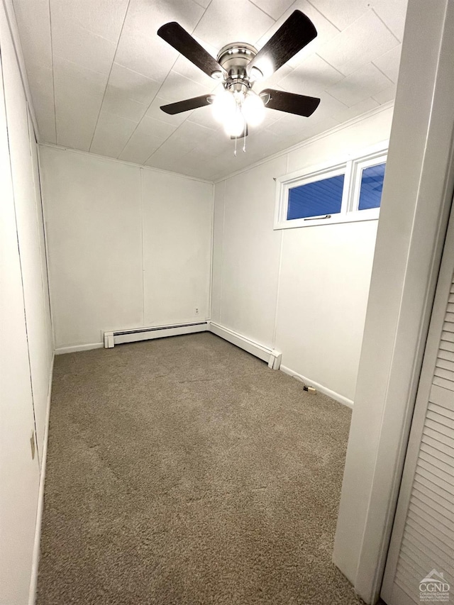 spare room featuring a baseboard heating unit, a ceiling fan, and carpet floors