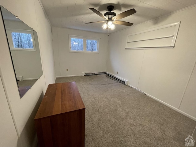 carpeted spare room featuring ceiling fan and ornamental molding