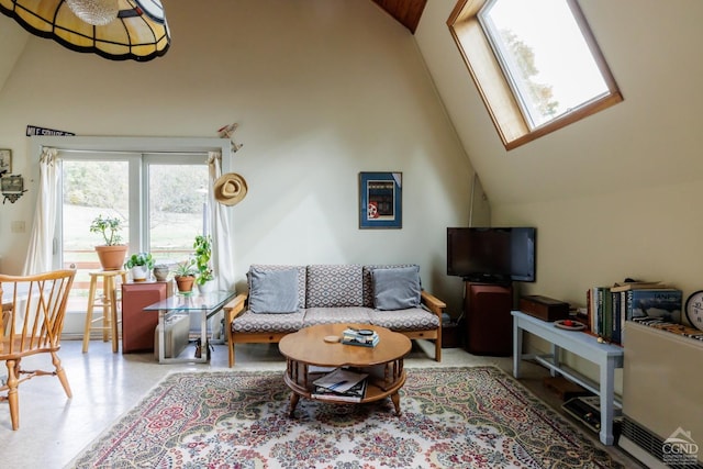 living room featuring high vaulted ceiling and a skylight