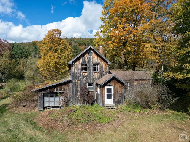 rear view of house with an outdoor structure