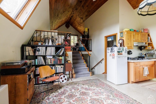 interior space with lofted ceiling with skylight, light carpet, white fridge, wood ceiling, and stainless steel gas cooktop