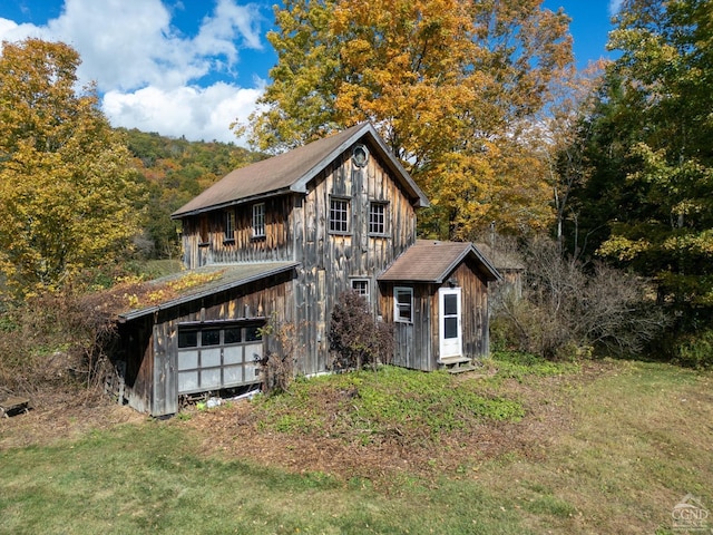 exterior space with a lawn and an outbuilding