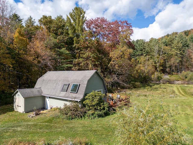 view of property exterior with a yard and a shed