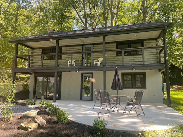 rear view of house with a balcony and a patio area