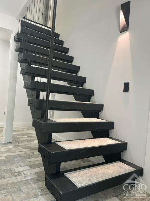 staircase featuring hardwood / wood-style flooring