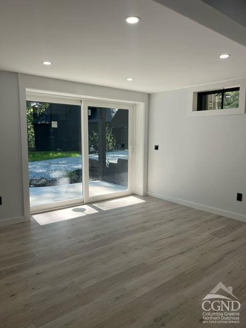 unfurnished room featuring hardwood / wood-style flooring and plenty of natural light