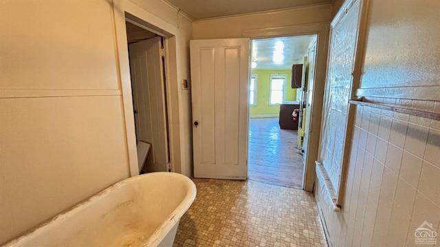 bathroom with a bathing tub and wood-type flooring