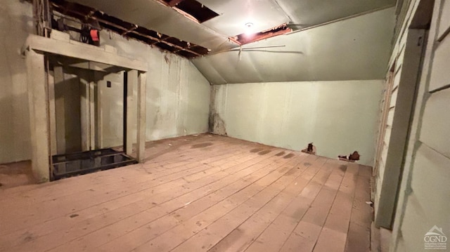 additional living space featuring light hardwood / wood-style flooring and lofted ceiling