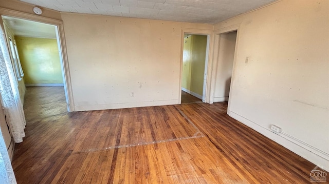 unfurnished room with hardwood / wood-style flooring