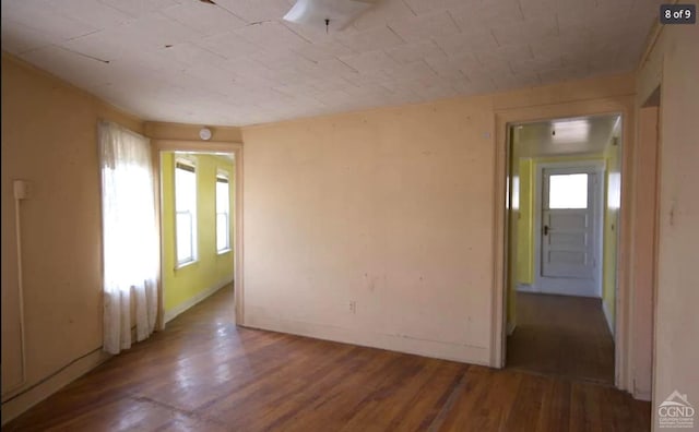 unfurnished room with wood-type flooring