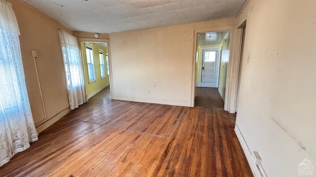 unfurnished room with hardwood / wood-style flooring