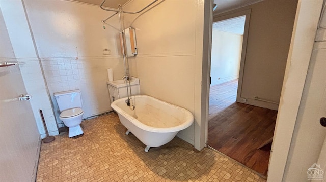 bathroom with hardwood / wood-style floors, shower with separate bathtub, and toilet