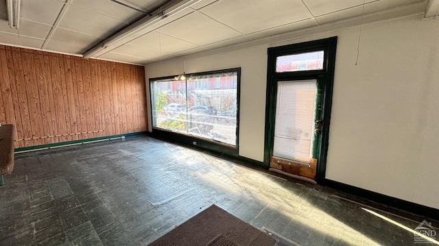 spare room featuring wooden walls