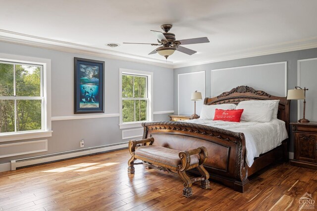 bedroom with wood-type flooring, baseboard heating, crown molding, and ceiling fan