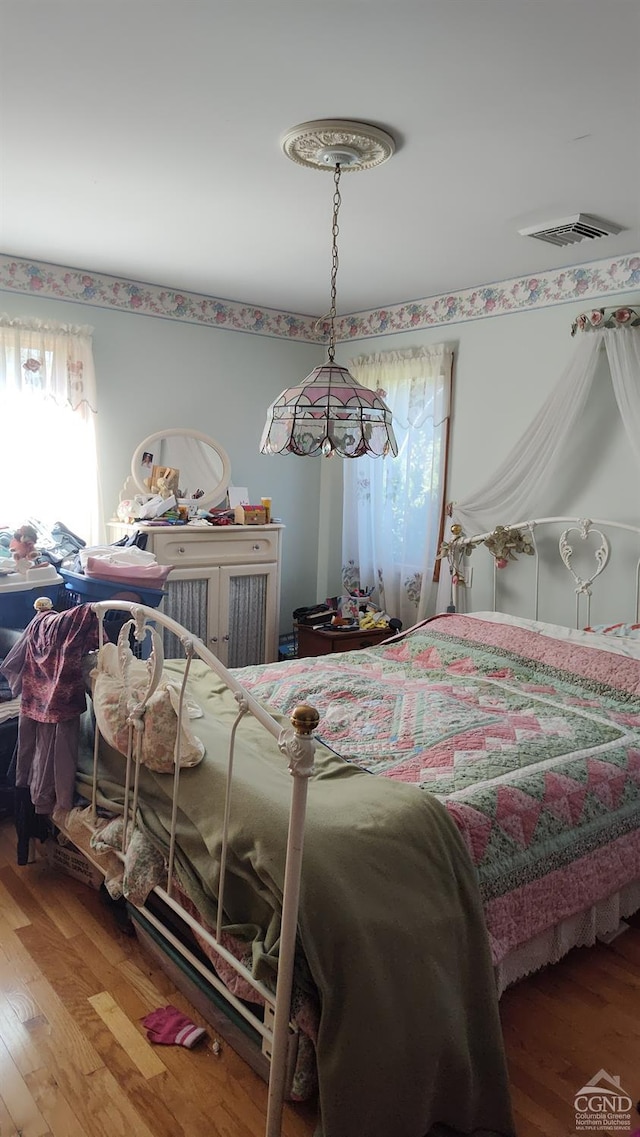 bedroom with wood-type flooring