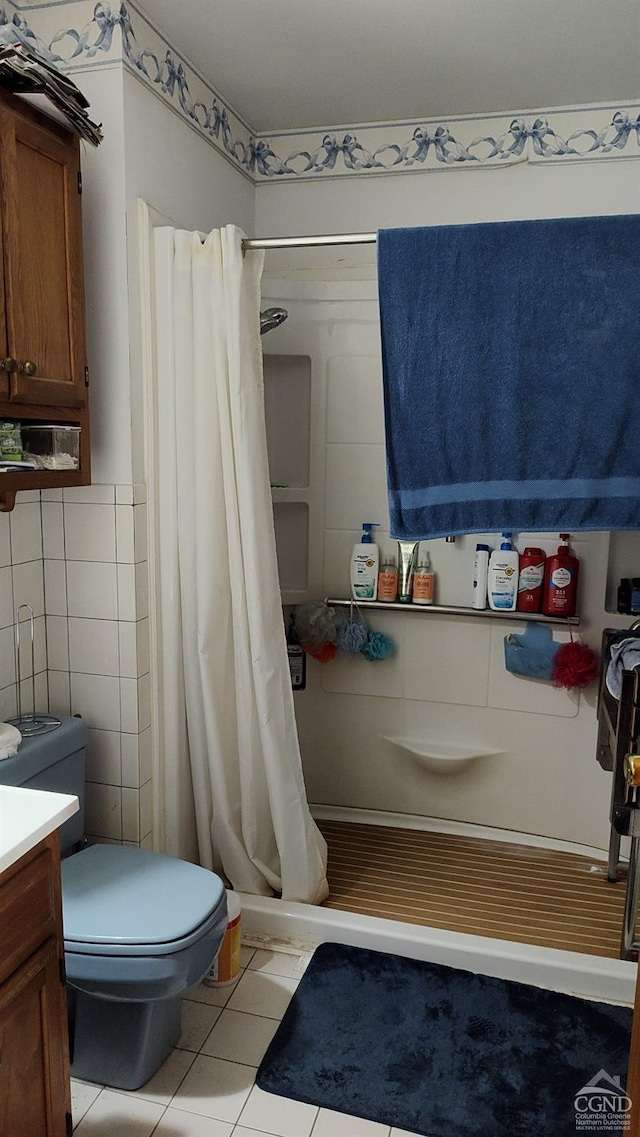 bathroom with tile patterned flooring, vanity, tile walls, and a shower with shower curtain