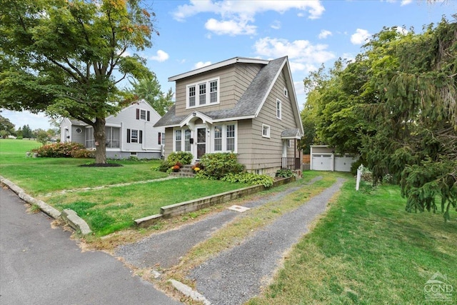 view of front of home with an outdoor structure and a front yard