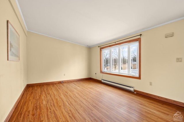 empty room with a baseboard heating unit, light wood-type flooring, and ornamental molding