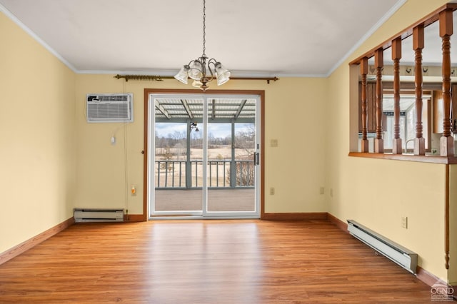 spare room with crown molding, a wall mounted air conditioner, and a baseboard heating unit