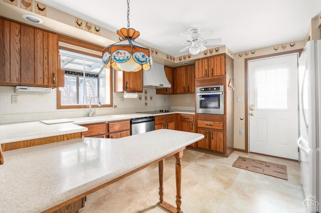 kitchen with light countertops, brown cabinets, custom exhaust hood, stainless steel appliances, and a sink