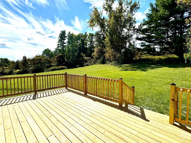 wooden deck with a lawn