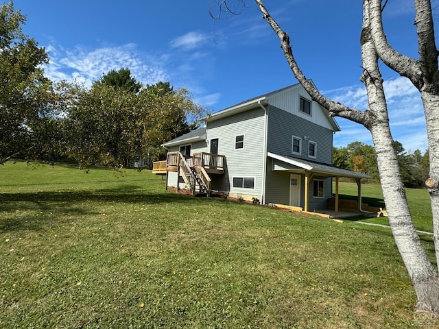 back of house with a wooden deck and a yard