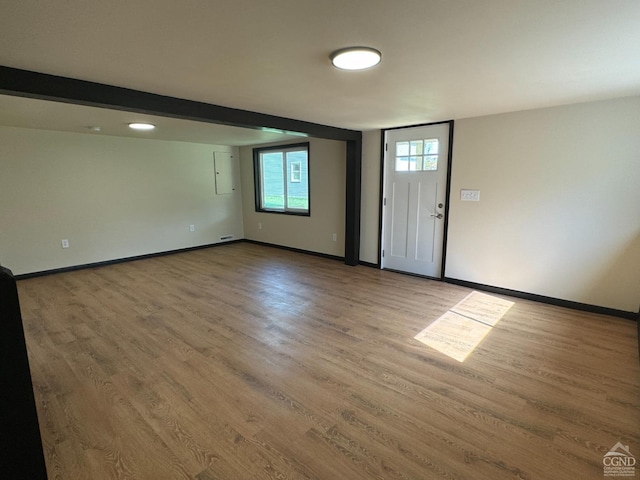 foyer entrance featuring wood-type flooring and electric panel