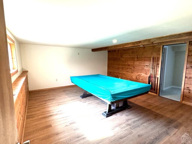 rec room with wood walls, hardwood / wood-style floors, and pool table