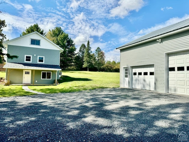 view of side of home featuring a garage and a lawn