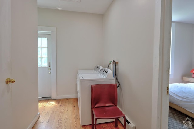 laundry area featuring washing machine and dryer and light wood-type flooring