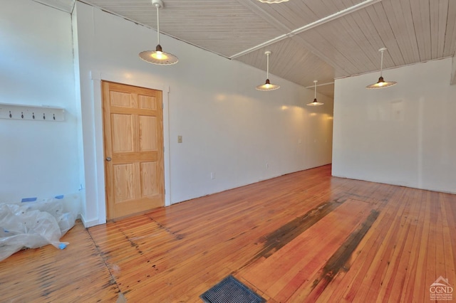 spare room featuring high vaulted ceiling and wood-type flooring